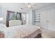 Bright bedroom featuring neutral walls, a ceiling fan, and double door closet at 755 Waterbrook Ter, Roswell, GA 30076
