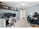 Spacious bedroom with modern ceiling fan and multiple desk and workstation setup at 755 Waterbrook Ter, Roswell, GA 30076