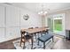 Elegant dining room with a modern chandelier and sliding doors to the backyard at 755 Waterbrook Ter, Roswell, GA 30076