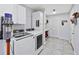 Bright laundry room featuring modern washer and dryer, white cabinetry, and tiled floor at 755 Waterbrook Ter, Roswell, GA 30076