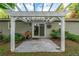 Cozy outdoor patio with a white pergola, patterned concrete pad, and sliding door access to the house at 755 Waterbrook Ter, Roswell, GA 30076