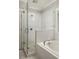 Elegant bathroom featuring a glass-enclosed shower and separate tub at 775 A Harrison Se Pl, Atlanta, GA 30315
