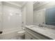 Bathroom featuring a shower-tub combo, single sink, and white marble countertops at 775 A Harrison Se Pl, Atlanta, GA 30315