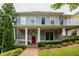 Charming two-story home featuring a welcoming front porch, red door, and beautifully landscaped front yard at 775 A Harrison Se Pl, Atlanta, GA 30315