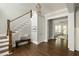 Foyer featuring hardwood floors, a staircase, bench seating, and an open view to the living room beyond at 775 A Harrison Se Pl, Atlanta, GA 30315