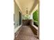 Covered front porch with brick flooring, decorative brick columns, and a view of the landscaped front yard at 775 A Harrison Se Pl, Atlanta, GA 30315