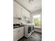 Bright laundry room featuring modern appliances and plenty of cabinet space at 775 A Harrison Se Pl, Atlanta, GA 30315