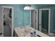 Bathroom with dual sinks, decorative lighting, and stylish fixtures at 1042 Emory Parc Pl, Decatur, GA 30033