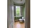 Half bathroom with green wainscoting, white fixtures, and a bright window at 1042 Emory Parc Pl, Decatur, GA 30033