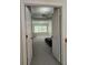 A bedroom viewed through an open doorway showcasing a tray ceiling and a large window for natural light at 1042 Emory Parc Pl, Decatur, GA 30033