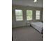 Bright bedroom with three large windows and neutral carpet at 1042 Emory Parc Pl, Decatur, GA 30033