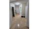 Hallway featuring hardwood floors, multiple doors, and access to a well-lit bathroom at 1042 Emory Parc Pl, Decatur, GA 30033