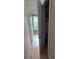 Hallway with wood floors leading to a bathroom with window at 1042 Emory Parc Pl, Decatur, GA 30033