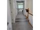 A hallway featuring carpeted stairs and a view into a bedroom, bathed in natural light at 1042 Emory Parc Pl, Decatur, GA 30033