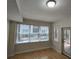 Sunlit living room with hardwood floors and large windows offering a pleasant outdoor view at 1042 Emory Parc Pl, Decatur, GA 30033