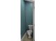 Powder room featuring a white toilet, gray floors, and a blue wall at 1042 Emory Parc Pl, Decatur, GA 30033