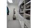 Bright walk-in closet with built-in shelving and drawers for optimal storage, plus a mirror at 1042 Emory Parc Pl, Decatur, GA 30033