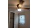 Bedroom with a wooden ceiling fan and light and white closet doors and a window with white curtains at 2137 Plantation Ln, Chamblee, GA 30341