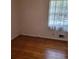 This bedroom boasts hardwood floors and a sunlit window at 2137 Plantation Ln, Chamblee, GA 30341