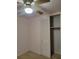 Bedroom with a ceiling fan, neutral colored walls, and bifold closet doors at 2137 Plantation Ln, Chamblee, GA 30341