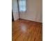 Bedroom with hardwood floors, a window and closet with bifold doors at 2137 Plantation Ln, Chamblee, GA 30341