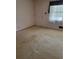 Empty room with natural light and carpeted floors at 2137 Plantation Ln, Chamblee, GA 30341