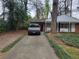 View of the house from the driveway featuring a convenient carport at 2137 Plantation Ln, Chamblee, GA 30341