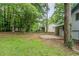Grassy backyard with a patio and green trees at 2347 Fairway Sw Cir, Atlanta, GA 30331