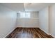Finished basement showcasing wood-look flooring, neutral paint, and natural light at 2347 Fairway Sw Cir, Atlanta, GA 30331