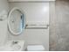 Bathroom featuring updated tilework and stylish oval mirror at 2347 Fairway Sw Cir, Atlanta, GA 30331