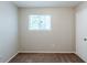 Empty bedroom with carpeted floor, window and white painted door at 2347 Fairway Sw Cir, Atlanta, GA 30331