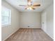 Bedroom features a window, ceiling fan with lights and carpeted floors at 2347 Fairway Sw Cir, Atlanta, GA 30331