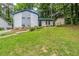 View of the home with a grassy front yard, front entry, and partial roof repair at 2347 Fairway Sw Cir, Atlanta, GA 30331