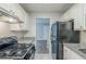 Functional kitchen with white cabinetry, granite countertops, and black appliances at 2347 Fairway Sw Cir, Atlanta, GA 30331