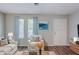 Virtually staged living room featuring new wood flooring and bathed in natural light at 2347 Fairway Sw Cir, Atlanta, GA 30331