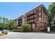 Apartment buildings with classic brick facade, private balconies and ample parking for residents and visitors at 2840 Peachtree Nw Rd # 307, Atlanta, GA 30305