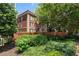 Brick apartment building with mature trees and landscaping, showcasing the Crestwood sign, for an inviting entrance at 2840 Peachtree Nw Rd # 307, Atlanta, GA 30305