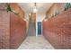 Unique building hallway featuring brick walls, tile flooring and stairs with greenery for added appeal at 2840 Peachtree Nw Rd # 307, Atlanta, GA 30305