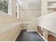 Bright hallway with neutral walls, a ceiling fan, and a staircase leading to the upper level at 2840 Peachtree Nw Rd # 307, Atlanta, GA 30305