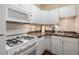 A well-lit kitchen featuring white cabinetry, subway tile backsplash and modern appliances at 2840 Peachtree Nw Rd # 307, Atlanta, GA 30305
