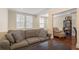 Cozy living room with a comfortable gray sofa, bright windows, and a view into the adjacent room at 2840 Peachtree Nw Rd # 307, Atlanta, GA 30305