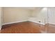 Bright living room featuring hardwood floors, neutral walls, and a white door to the outside at 2840 Peachtree Nw Rd # 307, Atlanta, GA 30305