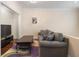Comfortable living room with a plush sofa, stylish coffee table, and a modern TV setup at 2840 Peachtree Nw Rd # 307, Atlanta, GA 30305
