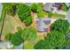Aerial view showcasing the house and backyard with mature landscaping and trees at 627 New England Way, Lawrenceville, GA 30046