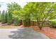 This backyard features mature trees, a wooden fence, and some shade at 627 New England Way, Lawrenceville, GA 30046
