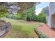 Large backyard with level lawn and mature landscaping at 627 New England Way, Lawrenceville, GA 30046