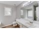 Bathroom features a vanity, modern fixtures, and a large mirror at 627 New England Way, Lawrenceville, GA 30046