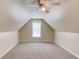 Spacious bonus room with plush carpeting, a window, and a ceiling fan at 627 New England Way, Lawrenceville, GA 30046