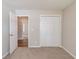 Bedroom showcasing a double door closet and a doorway to another room at 627 New England Way, Lawrenceville, GA 30046