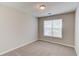 Cozy bedroom with neutral paint, carpet flooring, and a bright window at 627 New England Way, Lawrenceville, GA 30046